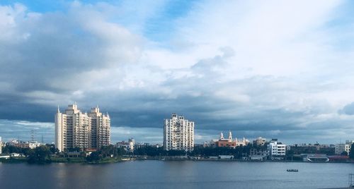 River by buildings against sky in city