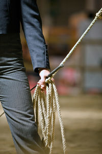 Close-up of man holding rope