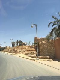 Street by road against sky