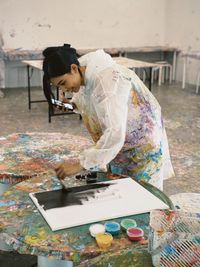 Rear view of man working on table