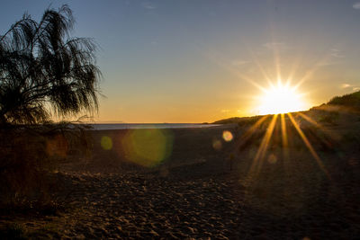 Scenic view of beach against sky during sunset