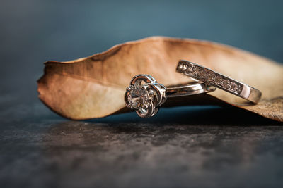 Close-up of wedding rings on table