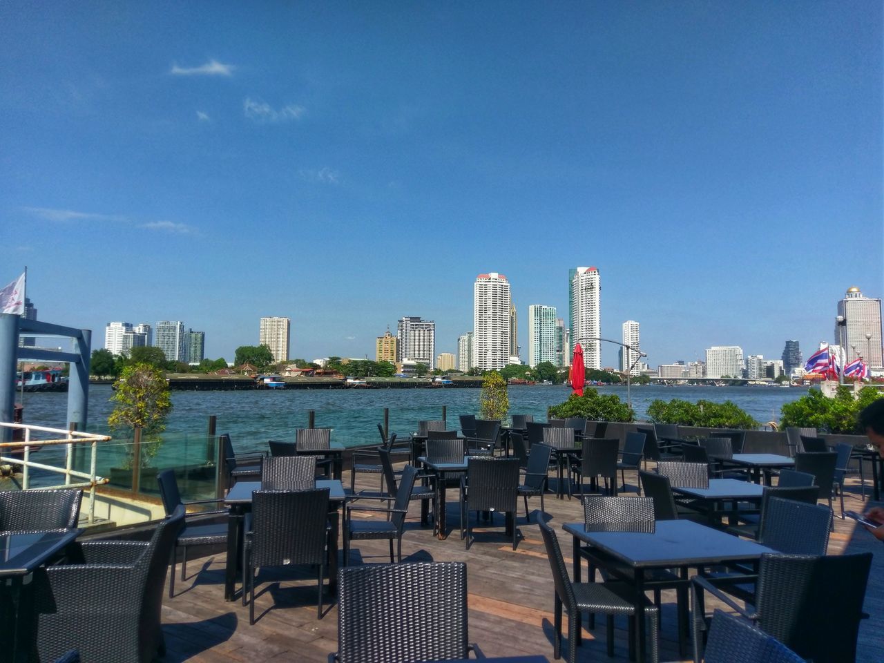 CHAIRS AND TABLES AGAINST BUILDINGS IN CITY