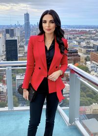 Portrait of young woman standing in city