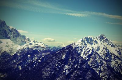 Panoramic view of mountains in winter and some white clouds on the sky in northern italy 