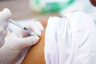 Close-up of hand holding syringe