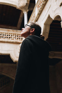 Rear view of man standing in temple