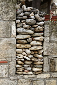 Stack of stones by stone wall