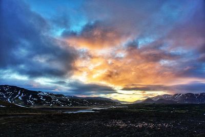 Scenic view of mountains against cloudy sky