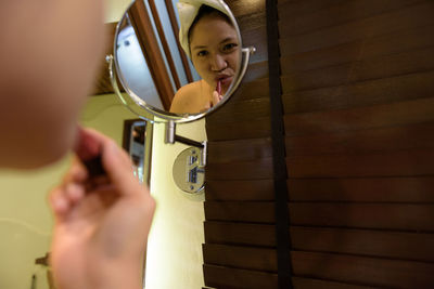 Rear view of a girl holding camera