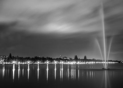 Scenic view of lake against sky at night