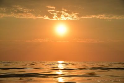 Scenic view of sea against orange sky