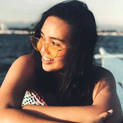 Close-up of beautiful young woman against sky