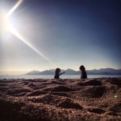 Surface level view of sand at beach against sky