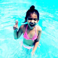 Portrait of smiling girl swimming in pool