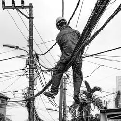 Low angle view of electricity pylon against sky