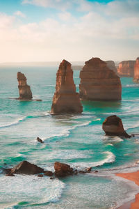 Scenic view of rocks in sea against sky