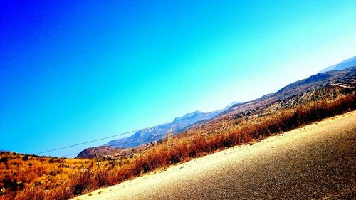 Scenic view of mountains against clear blue sky