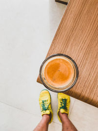 Low section of person standing with coffee