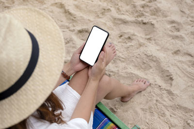 High angle view of man using mobile phone on beach