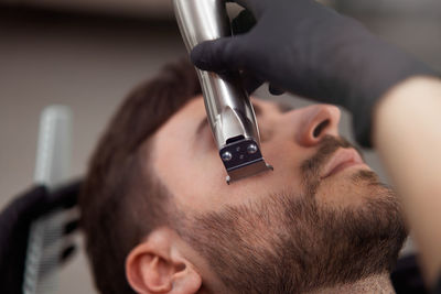 Close-up of young man holding camera