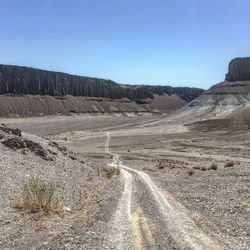 Scenic view of mountain road against clear sky