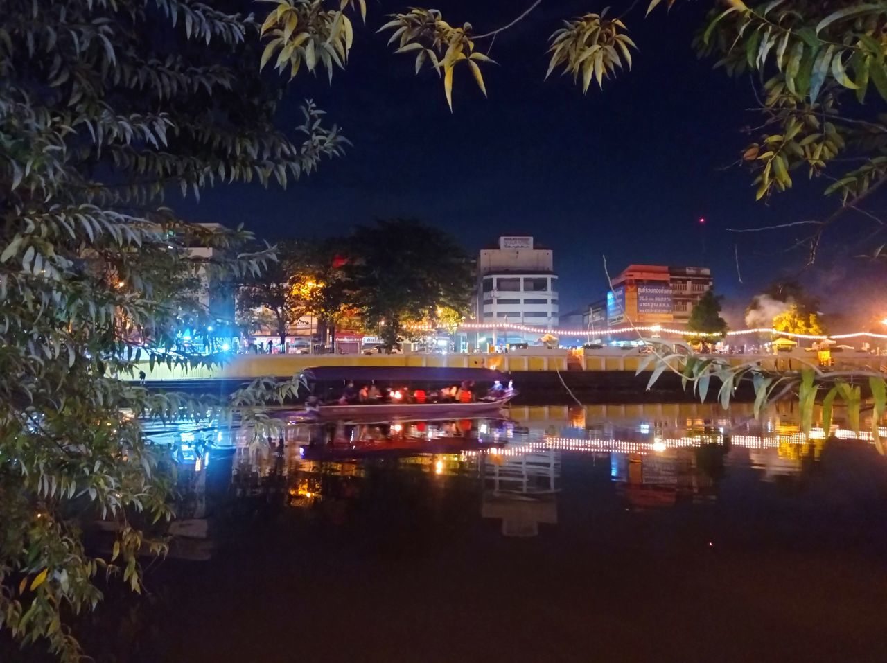 night, illuminated, architecture, water, built structure, building exterior, tree, reflection, city, travel destinations, nature, no people, plant, light, building, evening, celebration, palm tree, outdoors, travel, sky, holiday, event, cityscape, tourism, dusk, tropical climate, nautical vessel