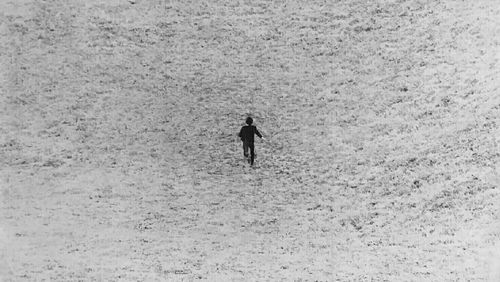 Full length of man walking on snow