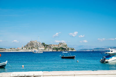 Boats in sea against sky