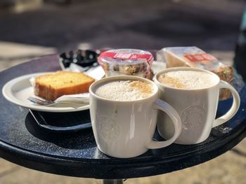 Close-up of food and drinks on table at sidewalk cafe