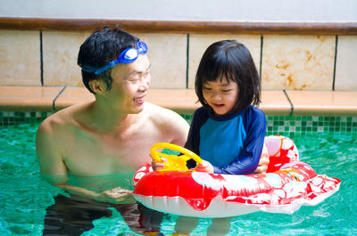 Father and daughter in swimming pool