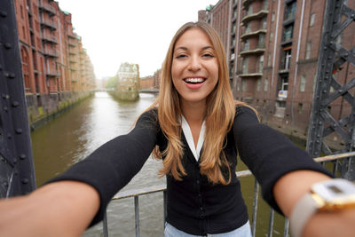 Girl taking self portrait in speicherstadt district in the port of hamburg, germany