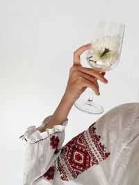 Holding a glass in vyshyvanka