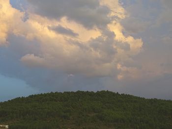 Scenic view of mountains against cloudy sky