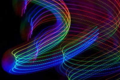 Close-up of light painting against black background