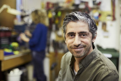 Portrait of smiling mature male volunteer at workshop