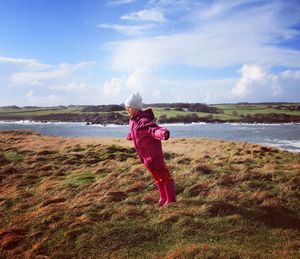 Girl on beach against sky