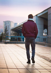 Full length rear view of man standing in city