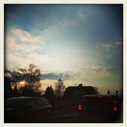 Cars on road at sunset
