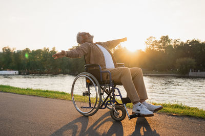 Rear view of man riding bicycle on street