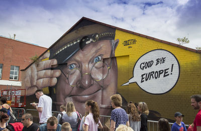 People on street against sky