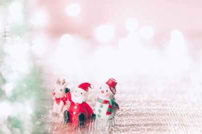 Close-up of figurine with toys against blurred background