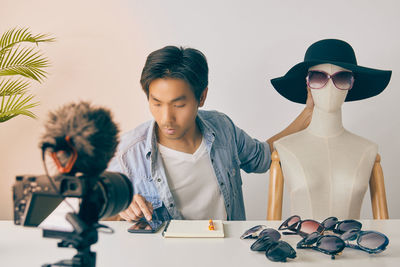 Man looking at camera while sitting on table