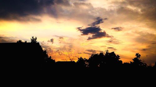 Silhouette trees against sky during sunset