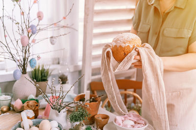 Happy easter holiday time spring. housewife woman holds baked pastry cake traditional bread in hands