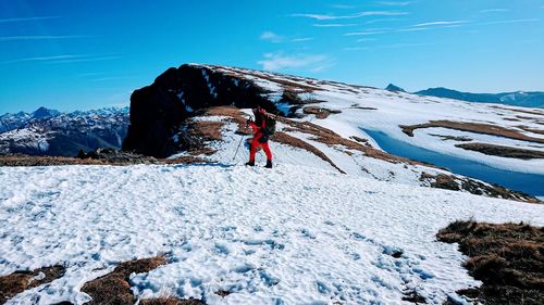 People on snowcapped mountain against sky