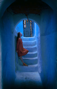 Woman with orange dress in chefchaouen iv