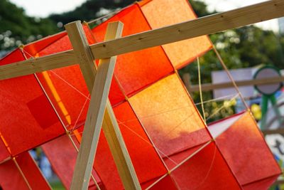 Low angle view of wooden fence against orange sky