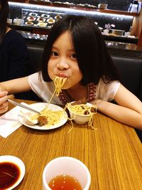Portrait of smiling man eating food