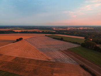 High angle view of field against sky during sunset